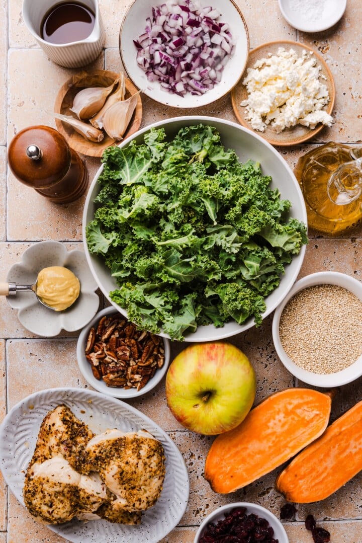 Ingredients for fall harvest kale salad displayed in small bowls.