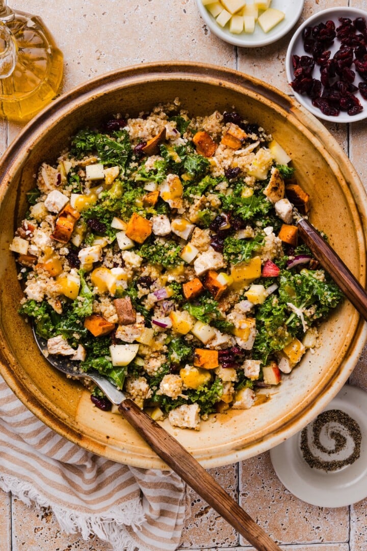 Fall harvest quinoa salad tossed in a large mixing bowl.