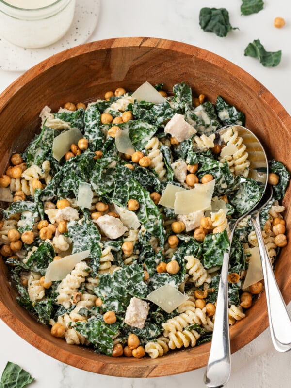 Kale Caesar Pasta Salad with chicken and chickpeas in a large mixing bowl.