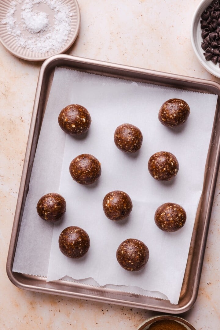 Pecan pie energy bites rolled into balls on sheet pan.