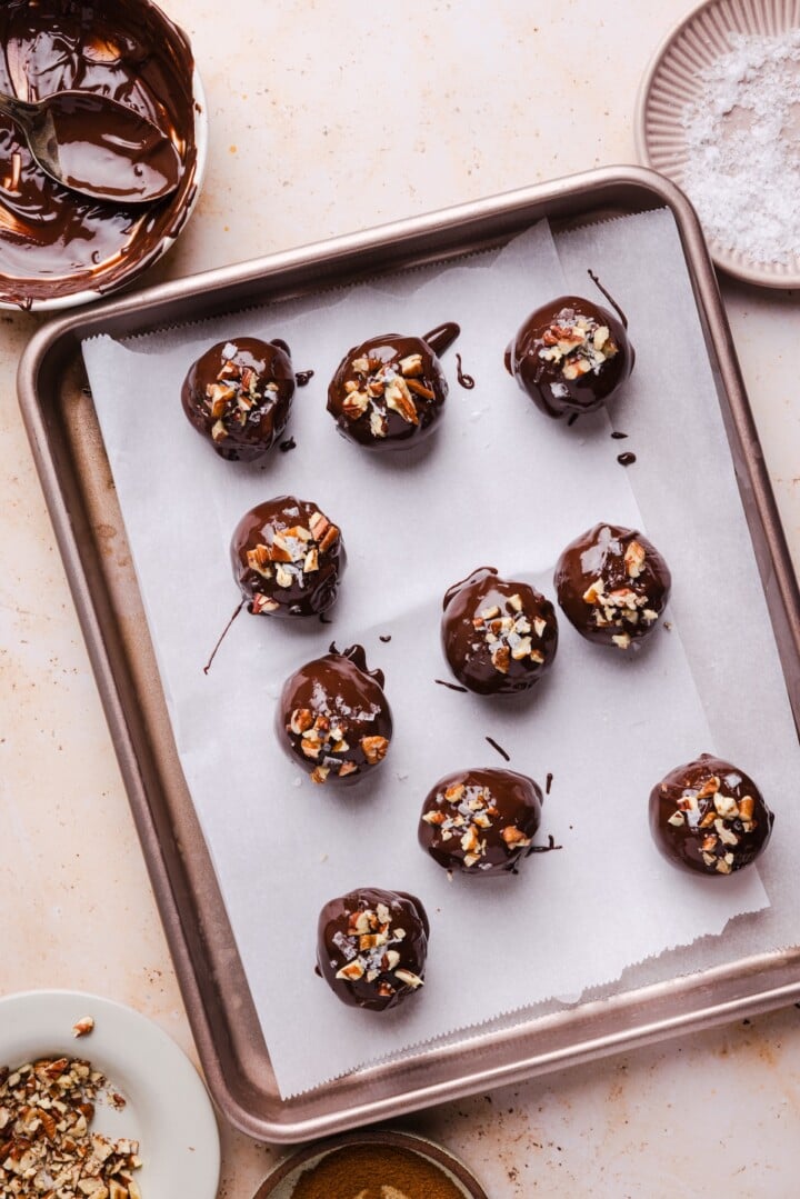 Pecan pie energy bites topped with sea salt and chopped pecans.